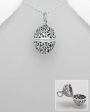 Barrel shaped filigree locket on silver chain