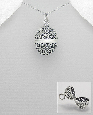 Barrel shaped filigree locket on silver chain