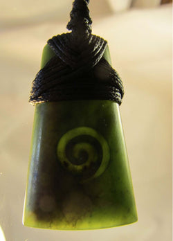tb216-mana-nz-wedge-shaped-greenstone-with-koru-carved-into-it-bound-at-the-top-by-black-cord_RL61NSKKN7JT.jpg